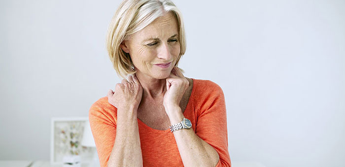 Mature woman suffering from neck and shoulder pain before visiting Boise chiropractor