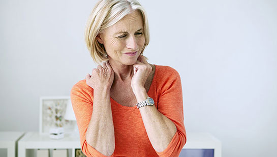 Mature woman suffering from neck and shoulder pain before visiting Boise chiropractor