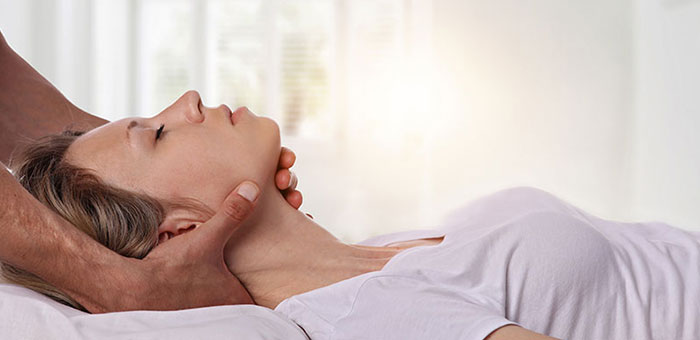 Woman receiving neck adjustment from Boise chiropractor