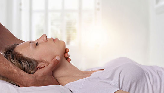 Woman receiving neck adjustment from Boise chiropractor