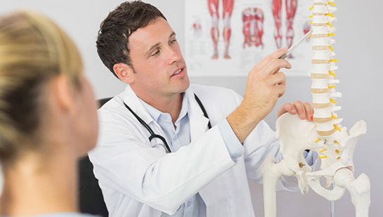 Boise chiropractor explaining spine misalignments to patient