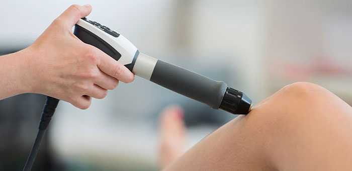 Patient receiving shockwave therapy in Boise for auto accident injury